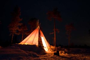 Traditional tent tipi with open fire inside.