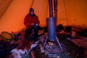 Alex inside our tipi tent with the hot stove.
