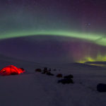 Northern lights, Aurora Borealis over tent camp on the tour: Sled dog adventure through Sjaunja and Kebnekaise