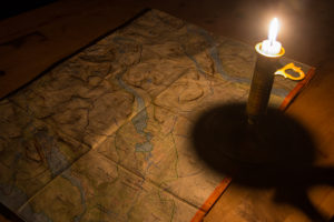 Mountain map reading candle light. Dog sled trip to the Gate of Sarek National Park