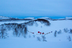 Dog sleds and tents between hills at the tour A Taste of Sarek National Park