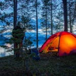 Lit Hilleberg tent in summer Swedish Lapland. Canoeing in the Pearl river Nature Reserve with Jokkmokkguiderna.